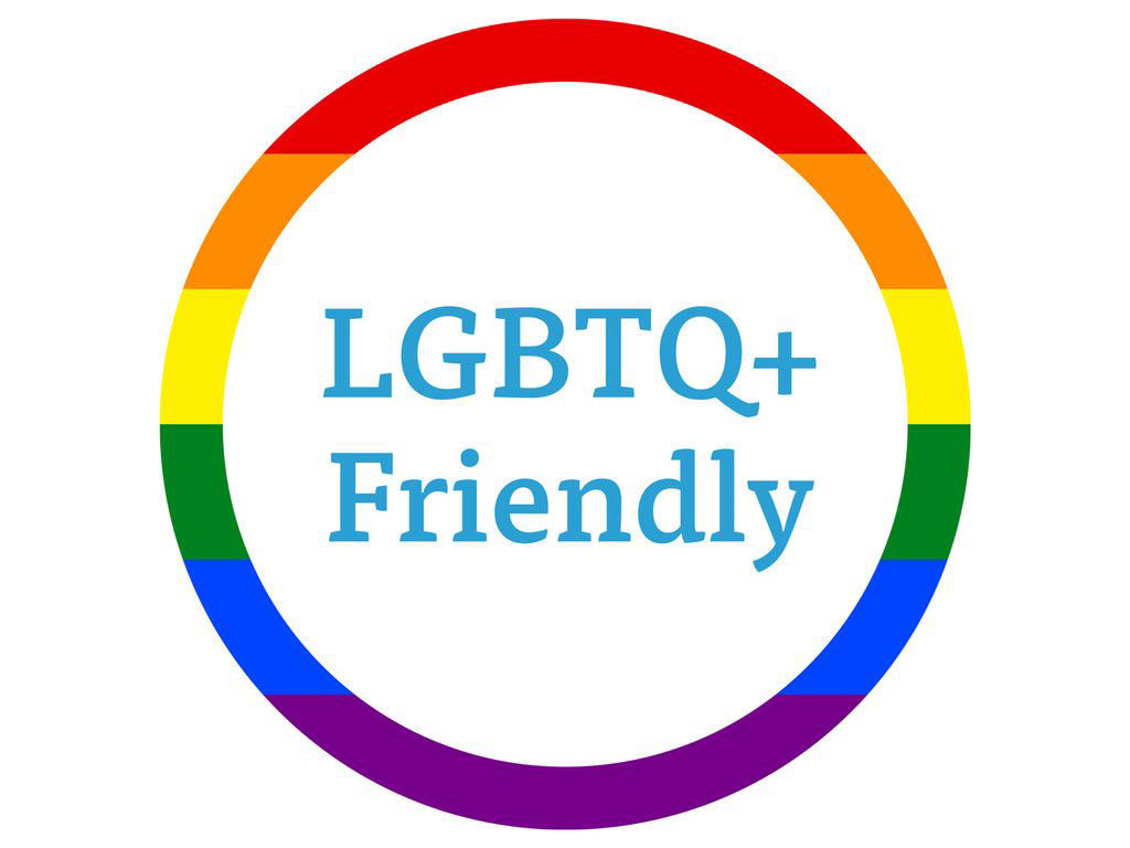 LGBTQ+ Friendly surrounded by a ring made of the rainbow flag. Demonstrates I offer services that value the LGBTQ+ community.